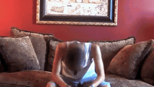 a woman sitting on a couch with her head down