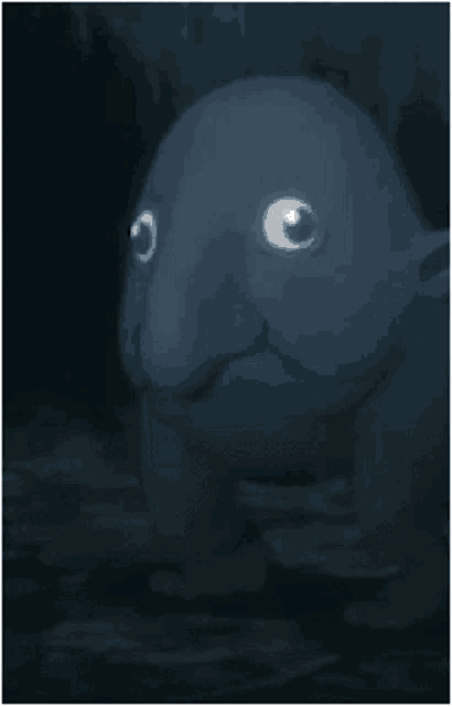 a cartoon character with a big nose and big eyes is standing in the dark looking at the camera .