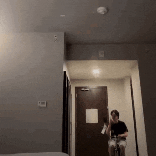 a man is riding a bicycle in a hotel room
