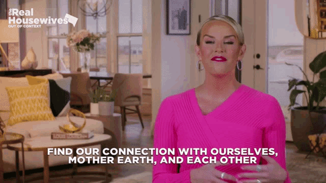a woman in a pink shirt says find our connection with ourselves mother earth and each other in a living room