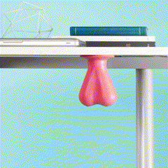 a person is holding a pink ball on a desk