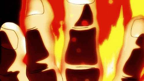 a close up of a person 's fingers with a fire background
