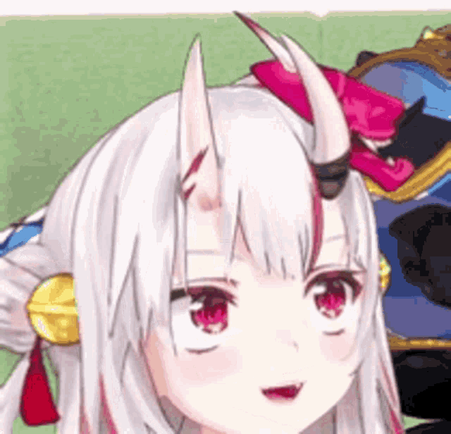 a close up of a girl with horns on her head .