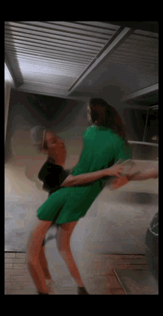 a blurry picture of a woman in a green dress