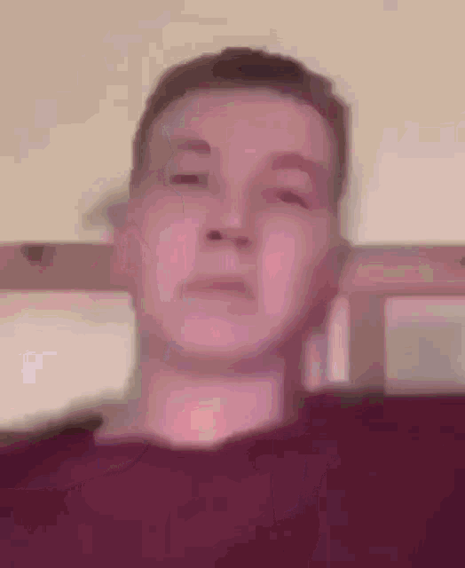 a close up of a person 's face with a purple background