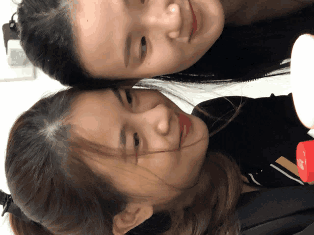 a woman 's head is resting on another woman 's shoulder while they smile for the camera