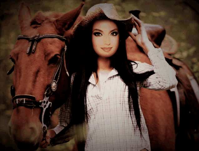 a woman wearing a cowboy hat is standing next to a horse