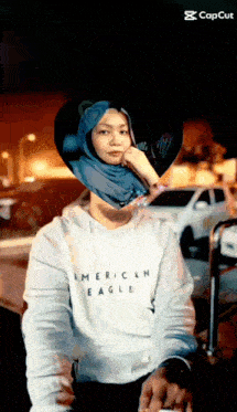 a woman wearing a white american eagle shirt