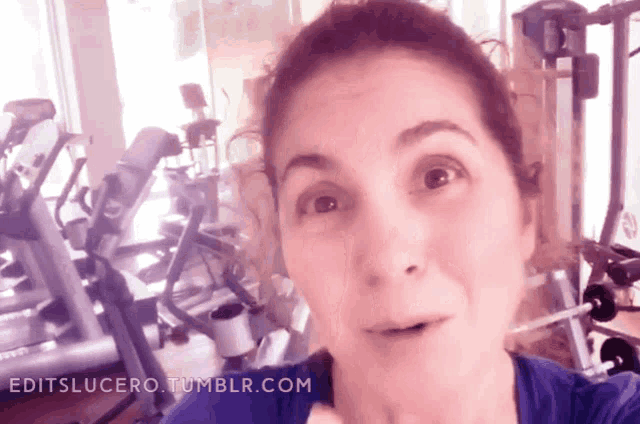 a woman taking a selfie in a gym with the website editslucero.tumblr.com in the lower right corner