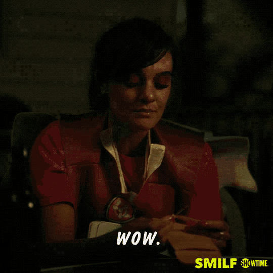 a woman sitting in a chair with the words wow on the bottom right