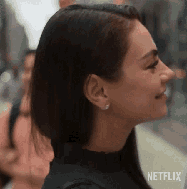 a close up of a woman 's face with a netflix logo behind her .