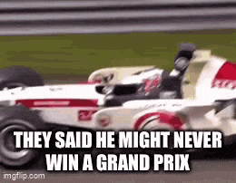 a race car is driving down a race track and they said he might never win a grand prix .
