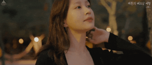 a close up of a woman 's face with korean writing on the bottom left