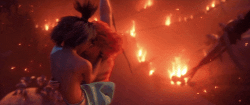 a man and a woman are hugging each other in front of a fire