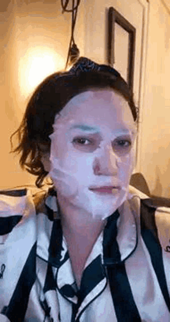 a woman is wearing a mask on her face .