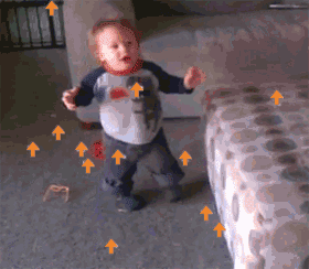 a little boy is standing in a room with arrows pointing upwards