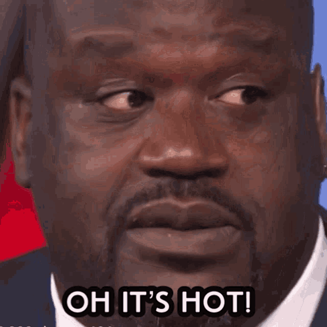 a close up of a man 's face with the words oh it 's hot