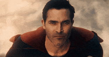 a close up of a man in a superman costume flying through the air