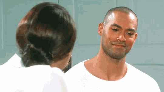 a man and woman are looking at each other and the man is smiling
