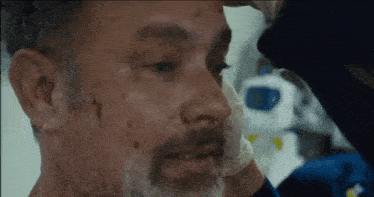 a close up of a man 's face with a bandage on his nose .