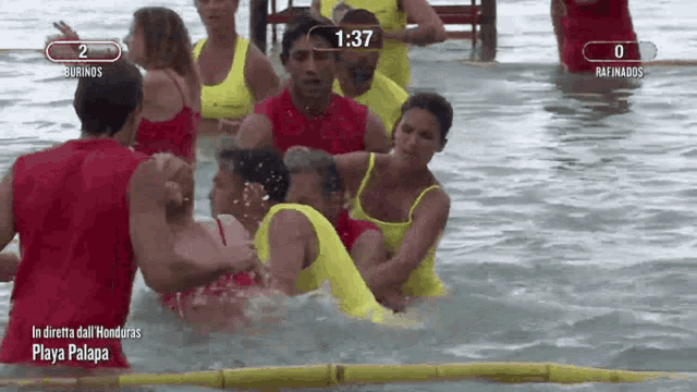 a group of people in the water with the time 1:37 on the screen