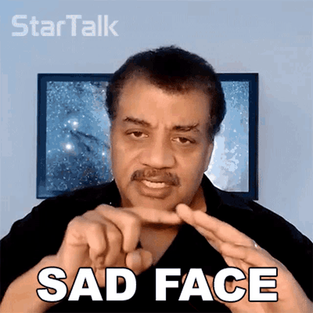 a man is making a sad face sign with his hands