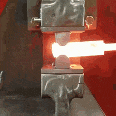 a close up of a machine with a red background and a light coming out of it