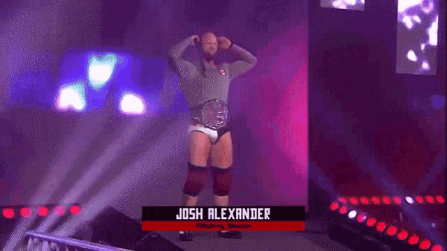 a wrestler named josh alexander is standing on stage
