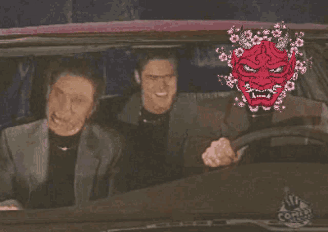 two men are sitting in a car with a sticker on the windshield that says corner shop