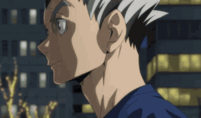 a close up of a man 's face with a blue shirt and white hair