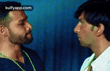 two men are looking at each other in a blurry photo .