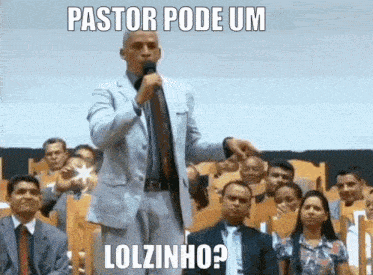 a man in a suit and tie is speaking into a microphone with the caption pastor pode um lolzinho ?