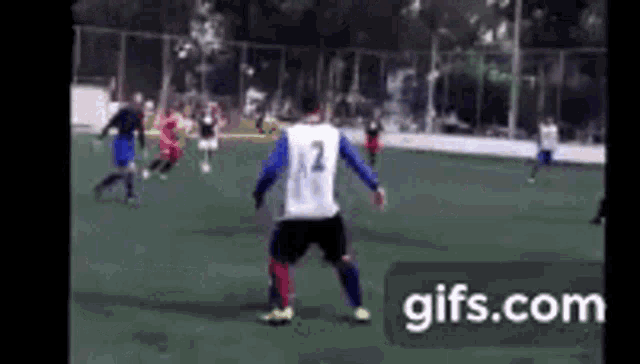 a group of soccer players are playing a game on a field . one of the players has the number 12 on his jersey .