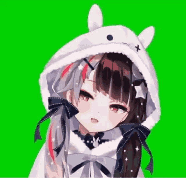a close up of a girl wearing a bunny hat on a green background .