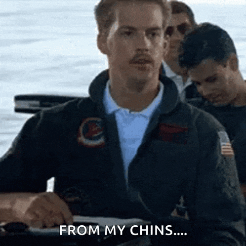 a man with a mustache is sitting on a boat with other men and says `` from my chins ... '' .