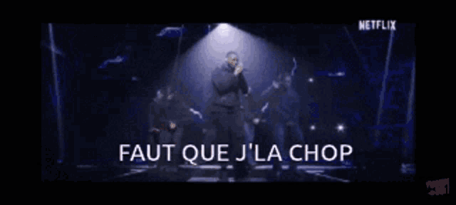 a group of men are standing on a stage with the words " faut que j'la chop " written on the bottom