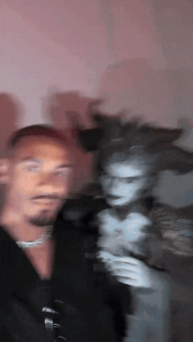 a blurry picture of a man standing next to a ghost