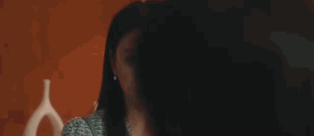 a close up of a woman 's face with long hair looking at the camera .