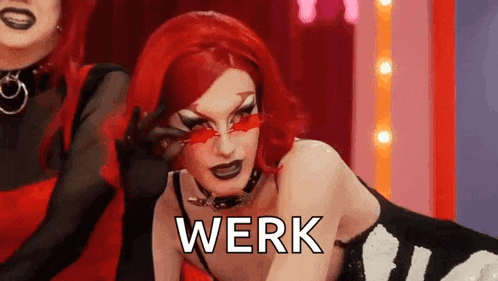 a drag queen with red hair is wearing red glasses and a choker and the word werk is written on her face .
