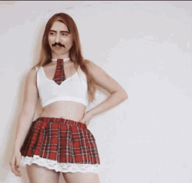 a woman with a fake mustache is wearing a plaid skirt and white top