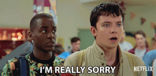 two young men are standing next to each other in a hallway and one of them is saying i 'm really sorry .