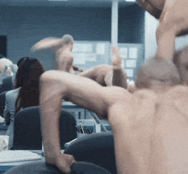a blurred image of a group of naked men in an office