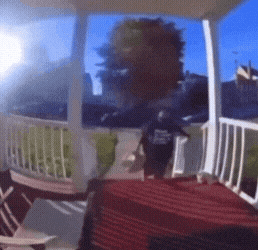 a person standing on a porch wearing a t-shirt that says ' i love you '