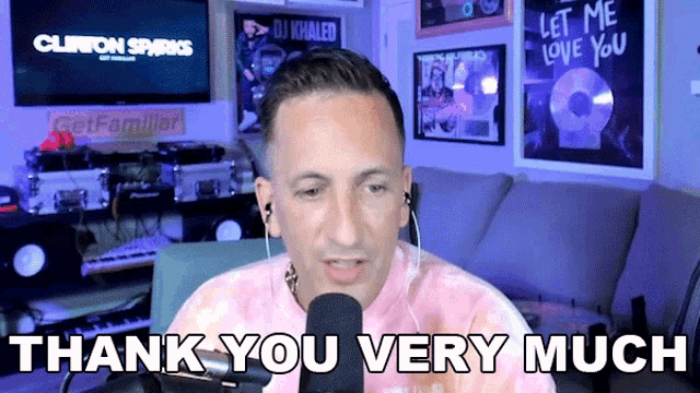 a man sitting in front of a microphone with the words thank you very much above him