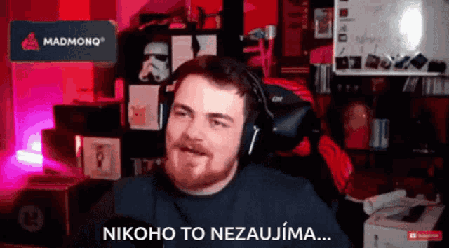 a man with a beard wearing headphones says nikoho to nezaujima