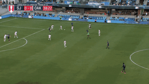 a soccer game is being played in a stadium with an advertisement for earthquakes