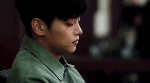 a close up of a man 's face with a tear running down his face