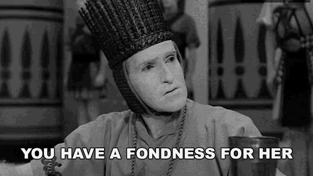 a black and white photo of a man with a crown on his head and the words `` you have a fondness for her ''