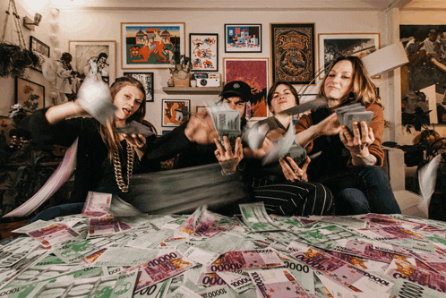 a group of people sitting on a bed with a pile of money that says ' 00000 ' on it