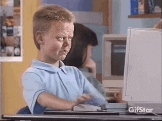 a young boy is sitting at a desk in front of a computer monitor with a gifstar logo on it